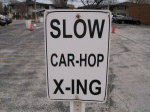 a sign that says slow carhop crossing